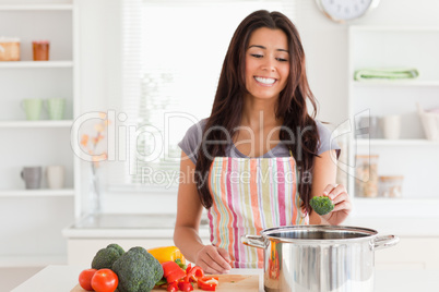 Gorgeous woman preparing vegetables while standing