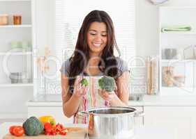 Lovely woman preparing vegetables while standing