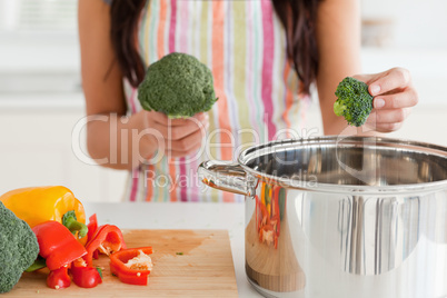 Female preparing vegetables while standing