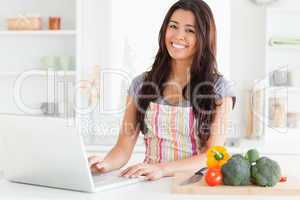 Beautiful woman relaxing with her laptop while standing