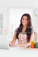 Attractive woman relaxing with her laptop while standing