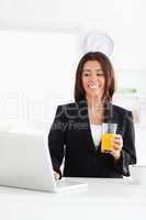 Attractive woman in suit relaxing with her laptop while holding