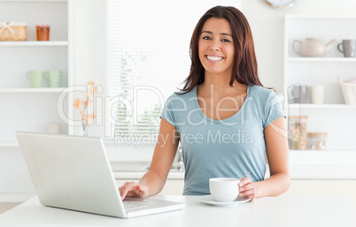 Good looking woman enjoying a cup of coffee while relaxing with