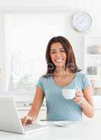 Attractive woman enjoying a cup of coffee while relaxing with he