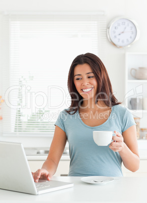 Charming woman enjoying a cup of coffee while relaxing with her