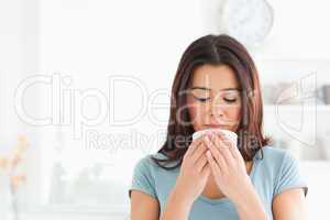 Charming woman enjoying a cup of coffee