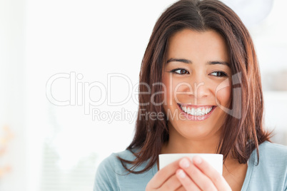 Portrait of a charming woman enjoying a cup of coffee