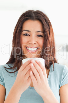 Portrait of a good looking woman enjoying a cup of coffee
