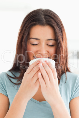 Portrait of a pretty woman enjoying a cup of coffee