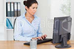 Pretty woman working on a computer while sitting