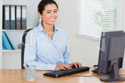 Good looking woman working on a computer while sitting