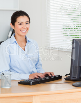 Charming woman working on a computer while sitting