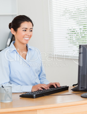 Lovely woman working on a computer while sitting