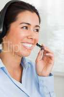 Portrait of an attractive woman with a headset helping customers