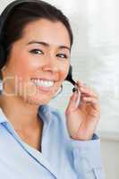 Portrait of a good looking woman with a headset helping customer