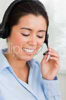 Portrait of a charming woman with a headset helping customers wh