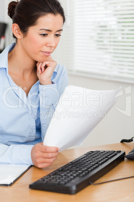 Attractive woman looking at a computer screen while holding a sh