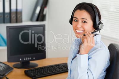 Beautiful woman wearing a headset and discussing while sitting