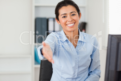 Good looking woman inviting somebody to seat while looking at th