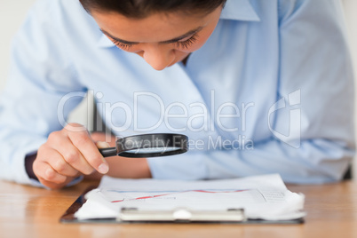 Attractive woman using a magnifyng glass