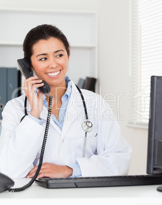 Beautiful woman doctor on the phone while sitting