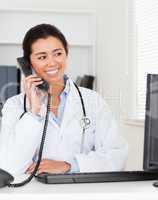 Beautiful woman doctor on the phone while sitting