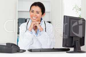 Attractive woman doctor posing while sitting