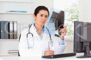 Charming female doctor looking at a x-ray