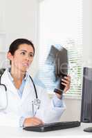 Attractive female doctor looking at a x-ray