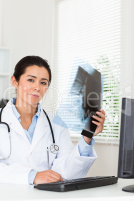 Good looking female doctor looking at a x-ray