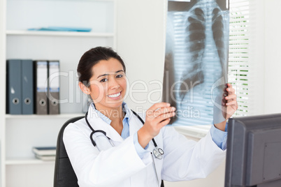 Lovely female doctor looking at a x-ray