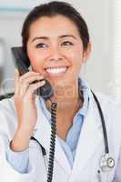 Beautiful female doctor on the phone and posing