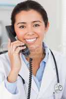 Pretty female doctor on the phone and posing