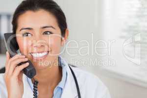 Attractive female doctor on the phone and posing