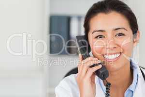 Gorgeous female doctor on the phone and posing