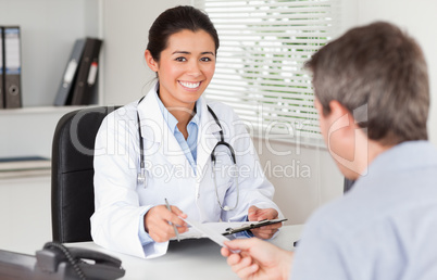 Patient giving his attractive woman doctor a piece of paper