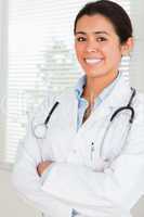 Lovely female doctor with a stethoscope posing while standing