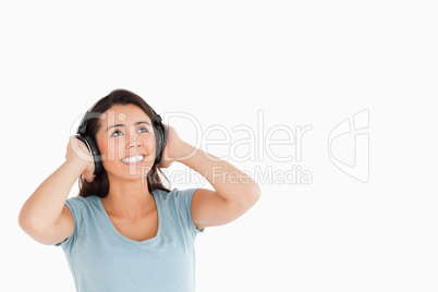 Attractive woman with headphones looking at something