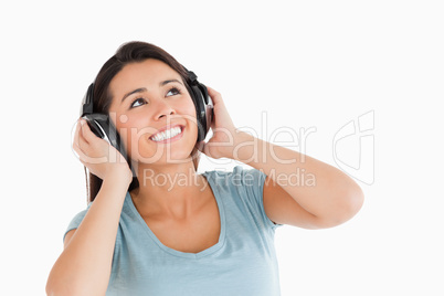 Beautiful woman with headphones looking at something