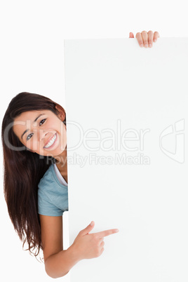 Good looking woman pointing at a board