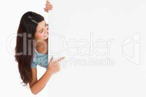 Gorgeous woman pointing at a board