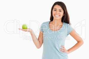 Good looking woman holding a green apple