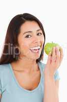 Beautiful woman eating a green apple