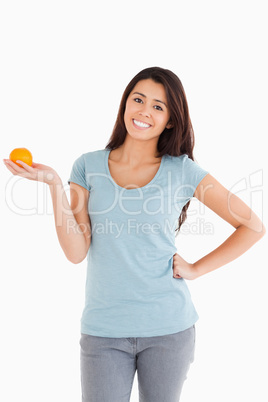 Good looking woman holding an orange