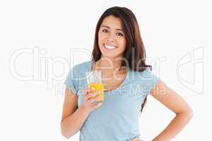Attractive woman holding a glass of orange juice