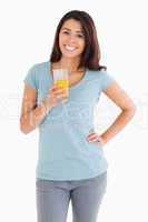 Gorgeous woman holding a glass of orange juice