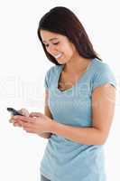 Beautiful woman writing a text on her mobile phone