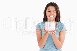 Attractive woman posing with a piggy bank