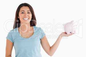 Beautiful female holding a piggy bank