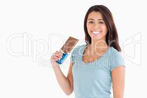 Lovely female holding a chocolate bar